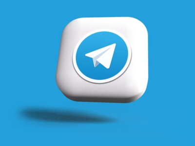 a blue and white square button with a paper airplane on it